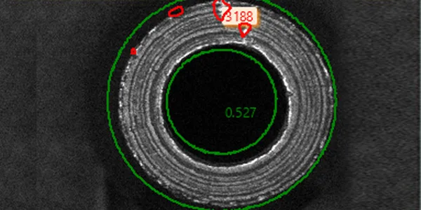 Bleeder screw camera view: part silhouette with the measurement overlays — the cross-hole seen through the cone